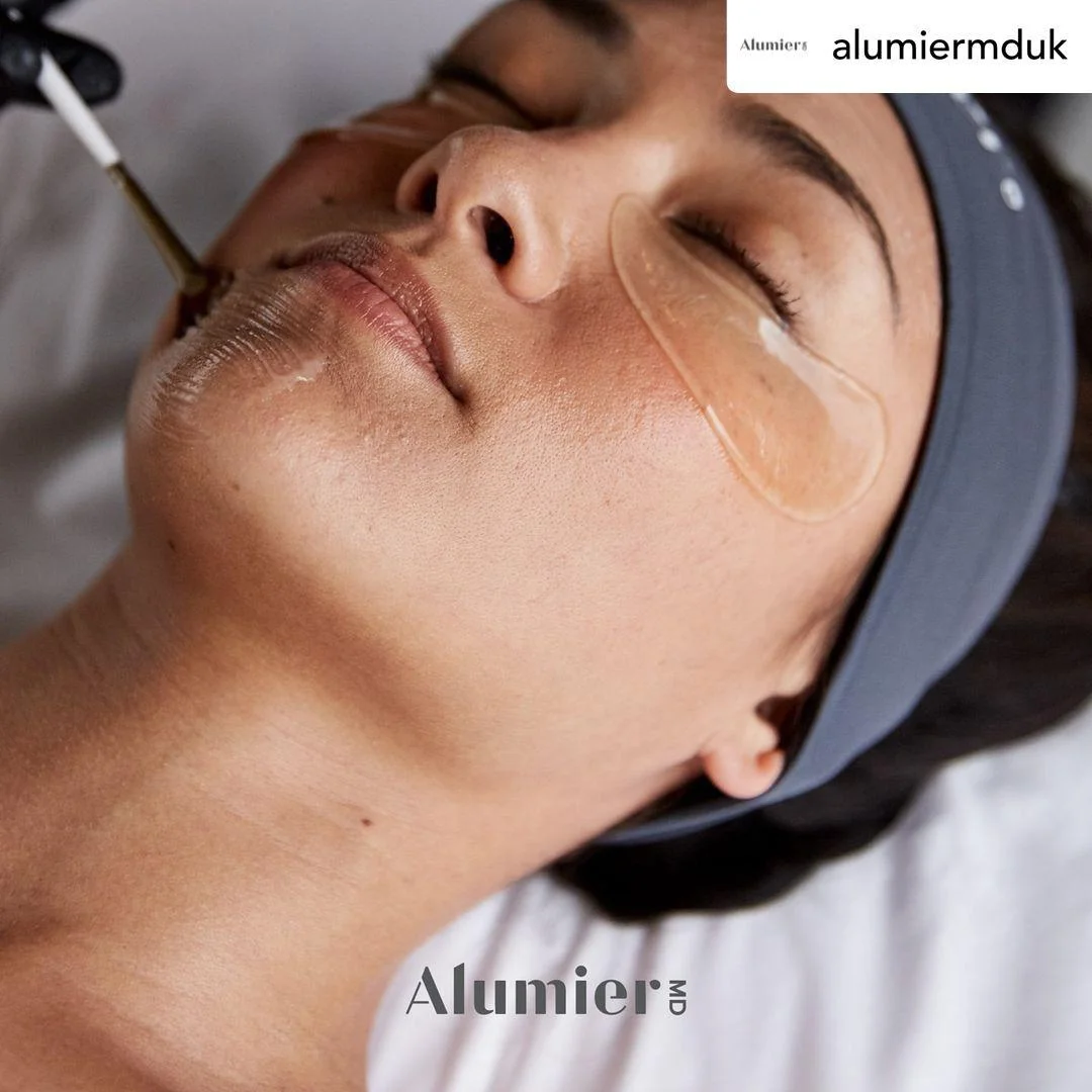 AlumierMD Radiant Glow peel being applied with a brush at LUMOS Clinic, Basingstoke — client wearing protective eye pads