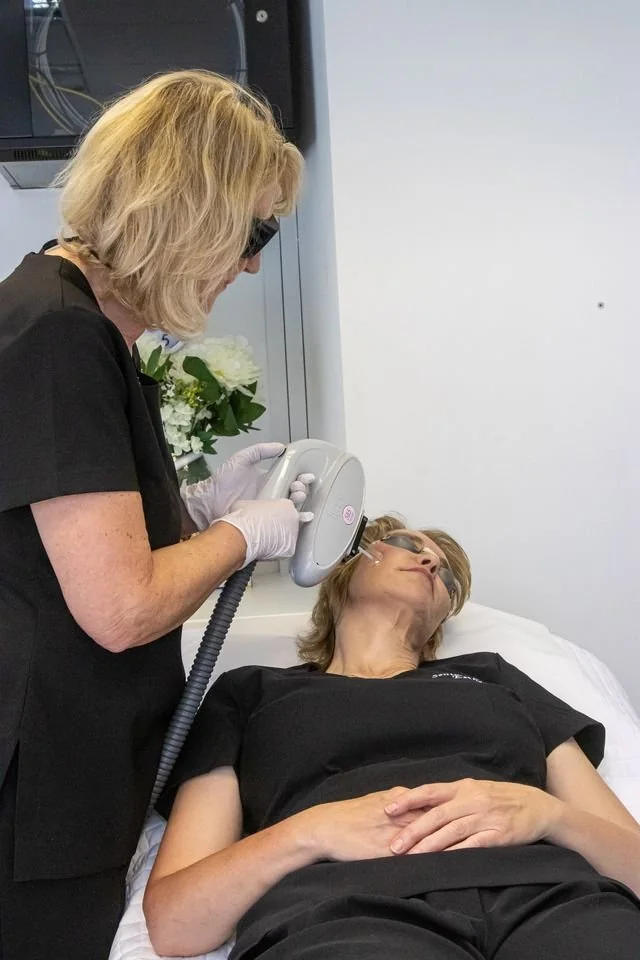 Anne treating a client with IPL for thread veins at LUMOS Clinic